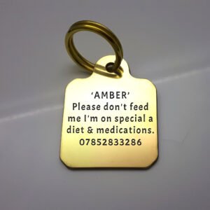 A solid brass pet tag with the name and telephone number along with the text "Please don't feed me I'm on special diet & medications" deeply engraved on one side. The other side is blank and can contain custom text.
