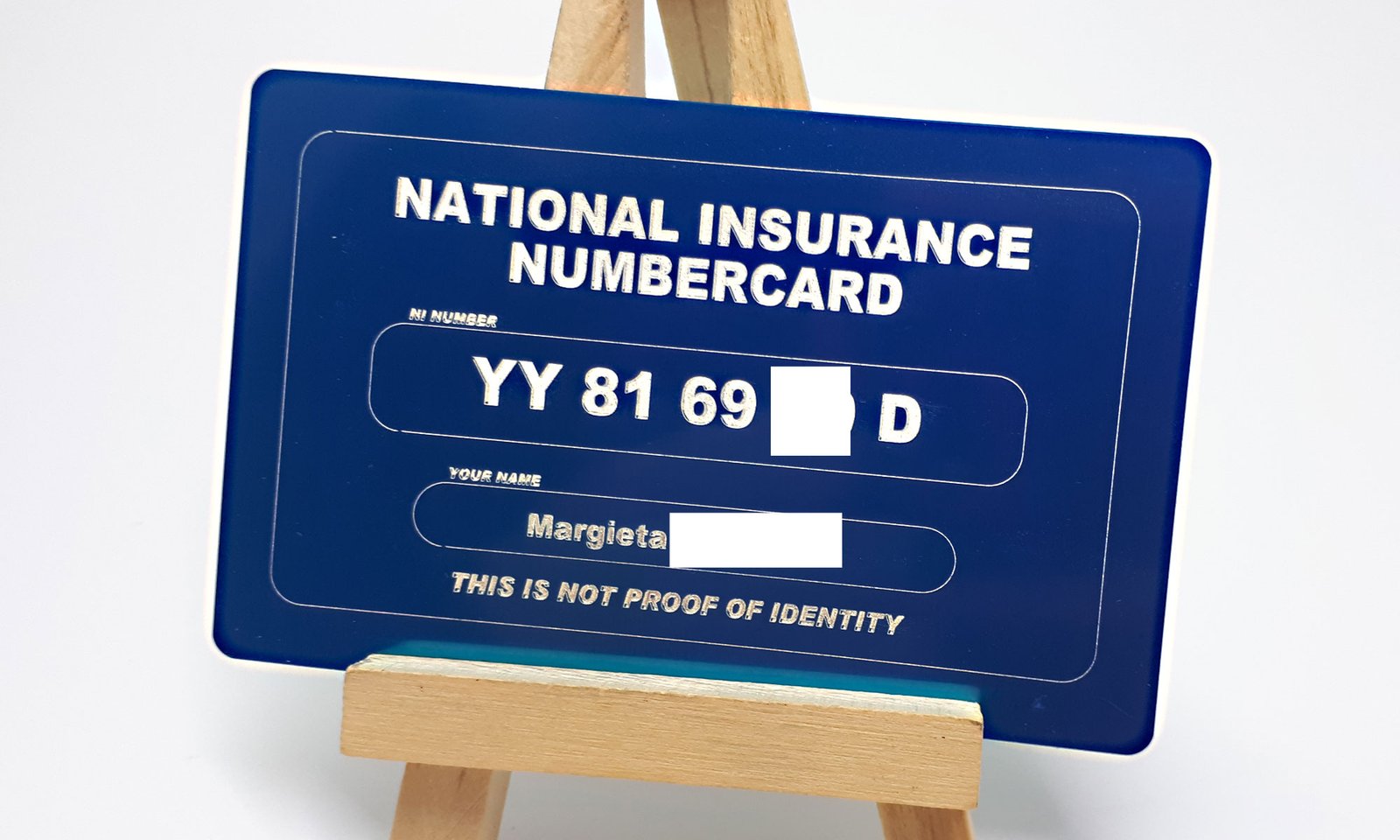 blue aluminium wallet size business card, laser engraved on one side with NI number and an option to engrave the NHS number on the reverse, or vice versa.